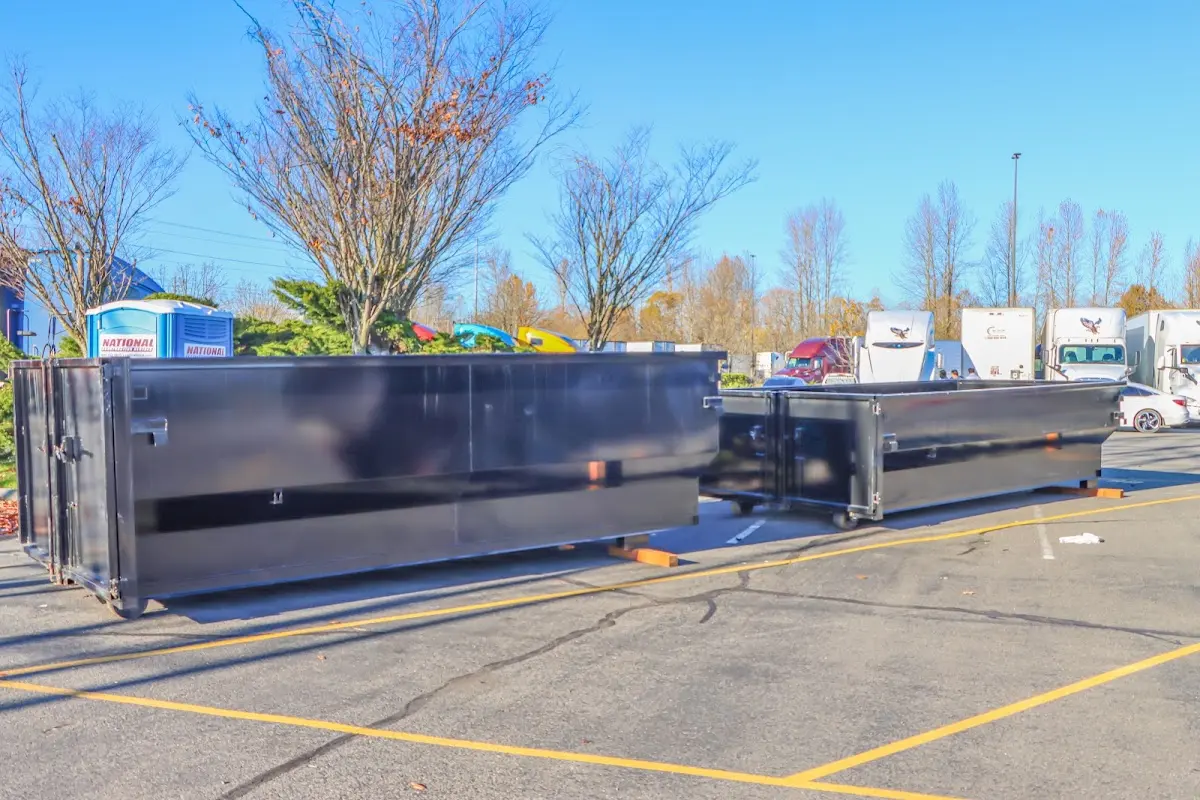 Professional dumpster rental service with roll-off container on residential driveway in Perris